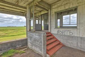 Abandoned concrete structure with stairs and windows. photo