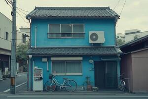 Blue house with bicycle and air conditioning unit. photo