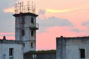 Abandoned tower at sunset with scaffolding. photo