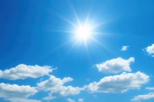 Bright sun shining over a clear blue sky with clouds. photo