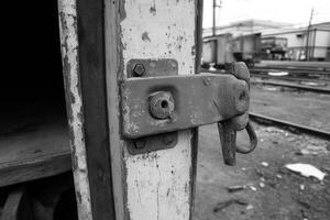 Close-up of a weathered lock on a train door. photo