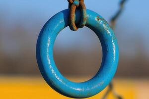 Close-up of a weathered blue playground ring. photo