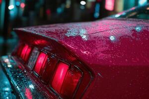 Close-up of a wet car tail light at night. photo