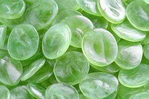 Close-up of glossy green oval-shaped objects. photo