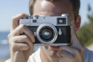 Person holding a camera, capturing a moment outdoors. photo
