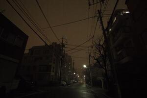 Dark urban street illuminated by distant lights. photo