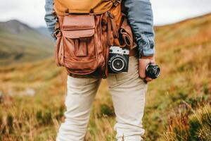 Person with cameras and a backpack in a natural setting. photo