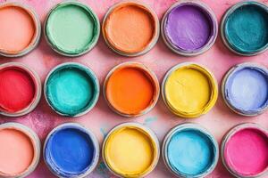 Colorful paint pots arranged on a surface for creativity. photo