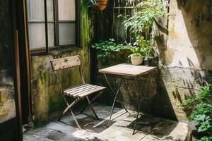 Cozy outdoor space with a table and chair. photo