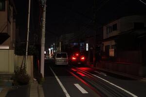 Nighttime street scene with a parked van and city lights. photo