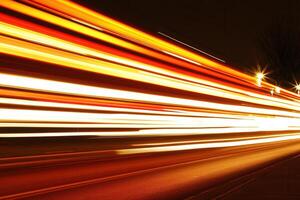 Night scene with light trails from moving vehicles. photo