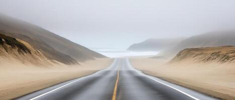 Coastal highway, fog, sand dunes, ocean view photo