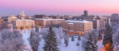 A city with snow covered trees and buildings at sunset photo