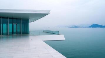 Modern coastal balcony, ocean view, misty mountains photo