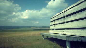 Rustic bench, scenic field, summer sky, peaceful view, relaxation photo