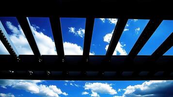 Sky glimpsed through modern slatted roof photo