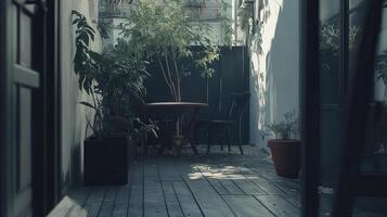 Sunlit urban patio with plants, table, chairs photo
