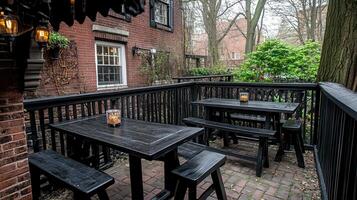 Urban Patio Dining Dark wood tables, brick building backdrop photo