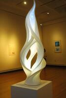 A sculpture in an art gallery with a white flame photo