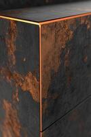 Close-up of dark, textured cabinet with copper trim photo