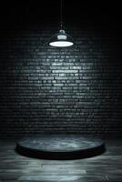 Dark, empty stage with brick wall and hanging lamp photo