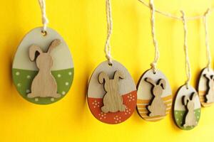 Easter decorative eggs with bunnies hanging on a rope photo