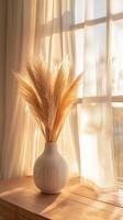 Warm Sunlight Illuminates Dried Flowers in a Vase on a Windowsill photo