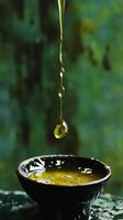 Golden Liquid Pouring into a Dark Bowl - Nature's Liquid Art photo