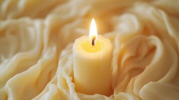 A Single Candle's Warm Glow in a Soft, Creamy Texture photo