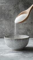 Sugar Pouring into Bowl - Sweet Treat Preparation photo