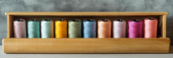 Wooden Box Filled with Colorful Sewing Threads photo