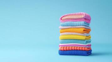 Colorful Stack of Clothes on a Light Blue Background photo
