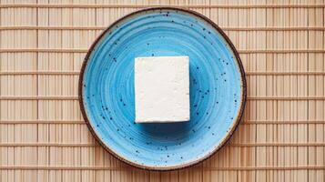 Single Tofu Block on a Blue Plate - Healthy and Simple photo