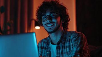 Smiling Person Working on Laptop at Night photo