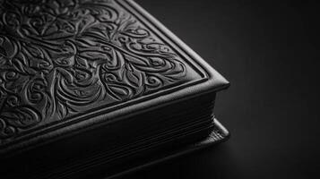 Black leather book with embossed floral design photo