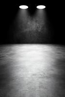 Empty Dark Room with Two Spotlights Illuminating Concrete Floor photo