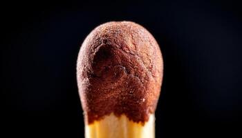 Close up of a Striking Matchstick Against a Dark Background Highlighting Its Texture and Details photo