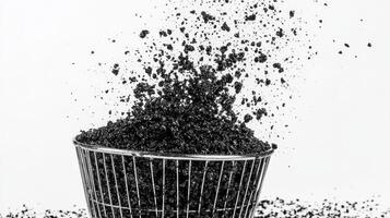 a black and white photo of a bucket filled with dirt