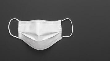Protective White Mask on Black, Healthcare Concept photo