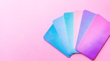 Assorted pastel color samples on pink backdrop photo