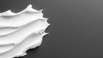 White cream strokes on dark surface photo