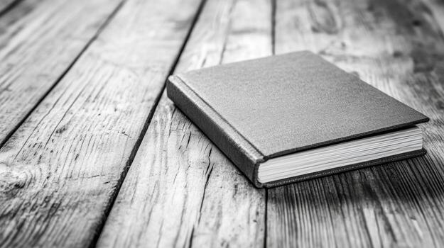 Monochrome closed book on wood surface photo