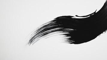 Black brush stroke on white paper photo