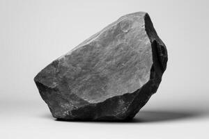 Rough black granite rock, mineral specimen close up photo
