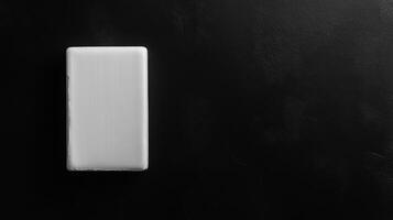 Smooth Cleansing Bar Shines Against Black Surface photo