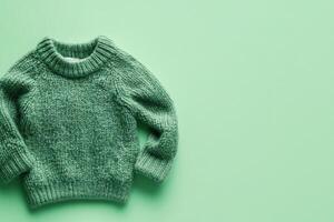 Green Knitted Sweater Garment on Solid Background photo