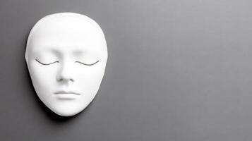Minimalist White Mask with Closed Eyes on Grey Background photo