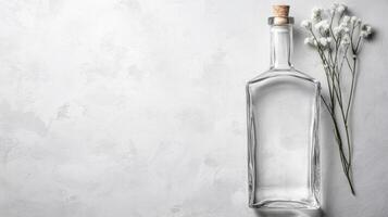 Clear Glass Bottle Stands with Delicate White Flowers photo