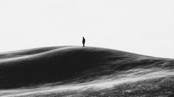 Solitary Figure Standing on Hilltop in Minimal Landscape photo
