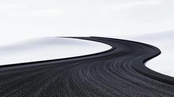 A winding road through the snow white expanses stretching away into the horizon photo